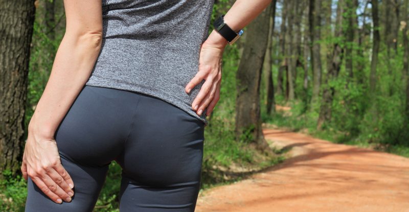 Woman runner with Cramp in the Hamstring Muscles