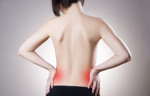 Woman with backache. Pain in the human body