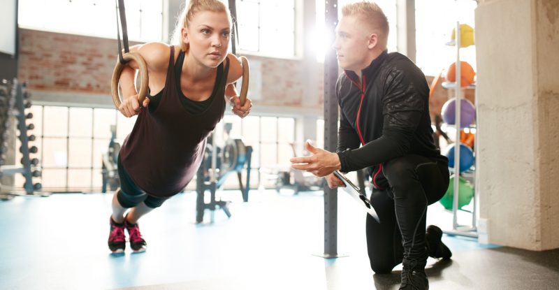 Woman exercising with a trainer at the gym