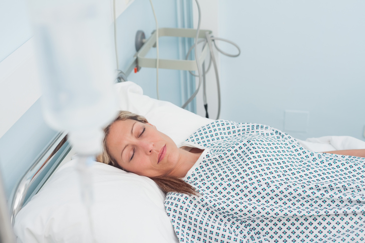 Female patient lying on a bed with closed eyes