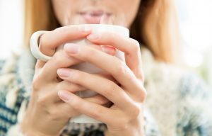 Woman drinking hot water.