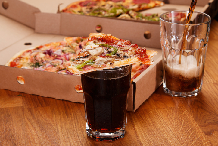 Glass of coke and pizza