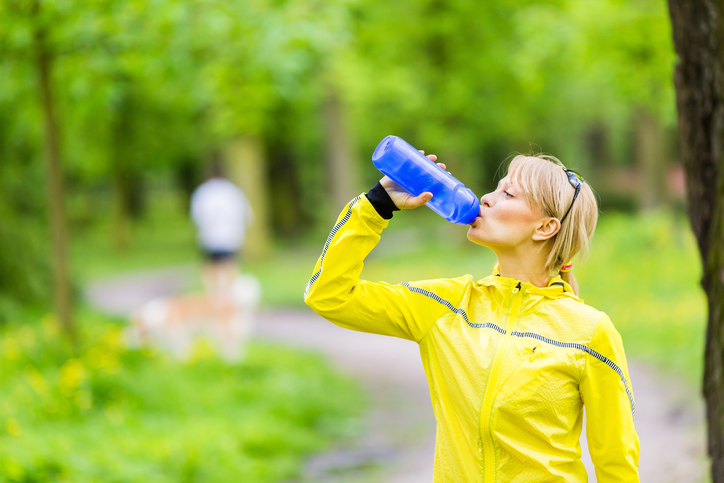 Female runner drinking water