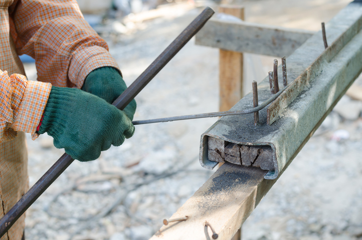 Labor hand bending reinforcement steel at construction