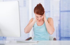 Businesswoman Suffering From Neckache At Computer Desk