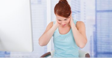 Businesswoman Suffering From Neckache At Computer Desk
