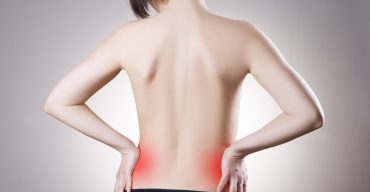 Woman with backache. Pain in the human body