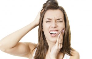 Young woman suffering from toothache