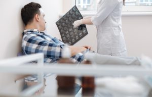 Nice professional doctor pointing at the X ray photo