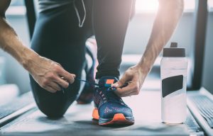 Portrait of a man tying shoelaces