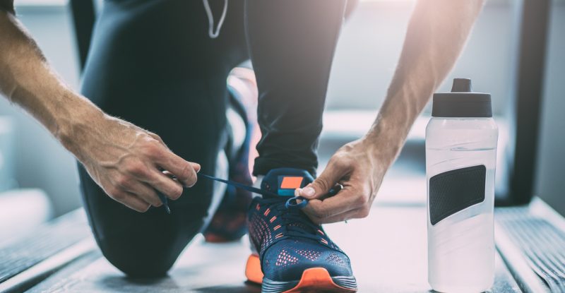 Portrait of a man tying shoelaces
