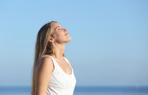 Beautiful blonde woman breathing happy